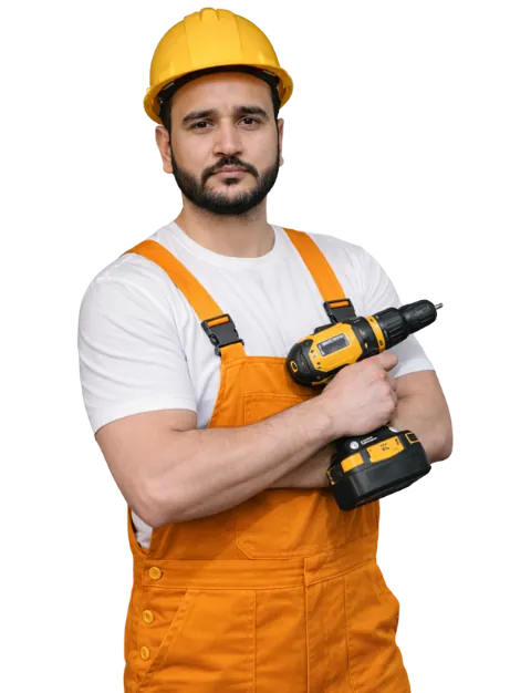 Garud Choudhary, founder of Secure Vision, in a hard hat and orange overalls holding a cordless drill